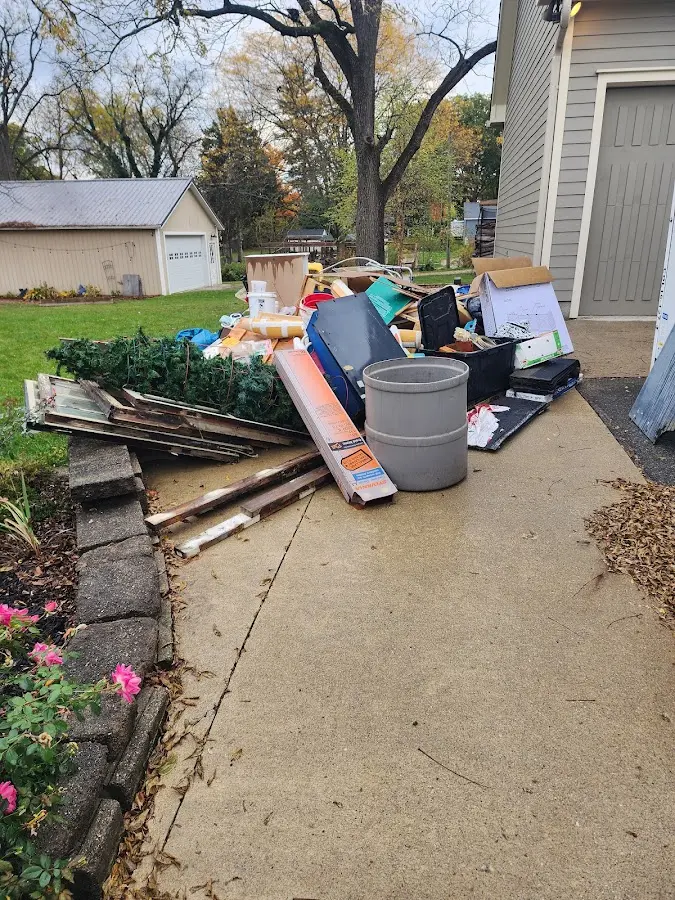 Dumpster being loaded with debris for Roofing Dumpster Rental in Victor